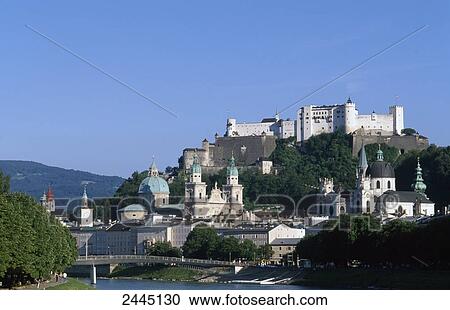 Buildings on waterfront with castle in background, Salzach River, Burg Hohenwerfen Castle, Salzburg, Austria View Large Photo Image Stock Image - Buildings on waterfront with castle in background, Salzach River, Burg Hohenwerfen Castle, Salzburg, Austria . Fotosearch