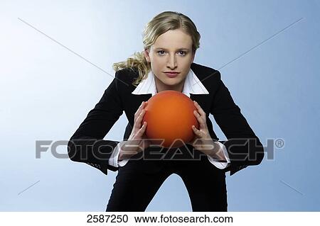 Businesswoman holding ball View Large Photo Image Stock Image - Businesswoman holding ball . Fotosearch
