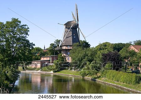 Canal with industrial windmill in background, East Frisia, Lower Saxony, Germany View Large Photo Image Stock Photo - Canal with industrial windmill in background, East Frisia, Lower Saxony, Germany . Fotosearch
