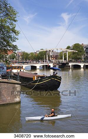 Canoeist on the Amstel River, Amsterdam, Netherlands, elevated view View Large Photo Image Stock Image - Canoeist on the Amstel River, Amsterdam, Netherlands, elevated view . Fotosearch