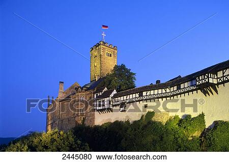 Stock Image - Castle lit up at dusk, Wartburg Castle, Eisenach, Thuringia, Germany . Fotosearch