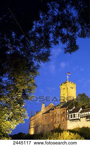 Stock Photo - Castle lit up at dusk, Wartburg Castle, Eisenach, Thuringia, Germany . Fotosearch