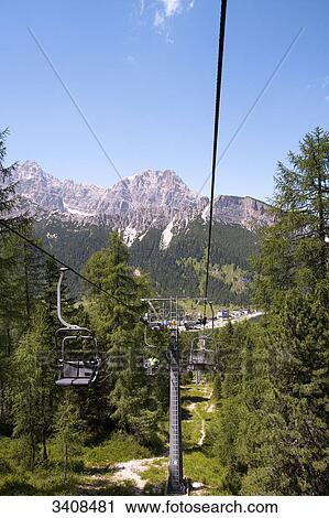 Chair lift Col de Varda, Monte Cristallo in the background, Venetia, Italy View Large Photo Image Stock Image - Chair lift Col de Varda, Monte Cristallo in the background, Venetia, Italy . Fotosearch