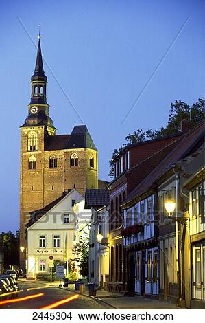 Picture - Church and timber-framed house lit up at dusk, St. Stephan's Church, Altmark, Saxony-Anhalt, Germany . Fotosearch