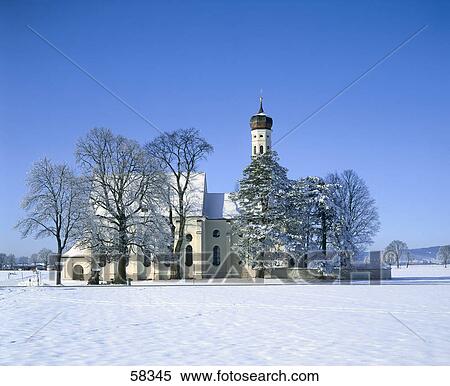 Stock Photography - Church on snow-covered landscape, Saint Coleman's Church, Schwangau, Germany . Fotosearch