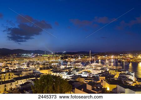 Stock Image - City and harbor lit up at night, Ibiza, Balearic Islands, Spain . Fotosearch