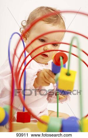 Close-up of baby playing with toy View Large Photo Image Stock Image - Close-up of baby playing with toy . Fotosearch