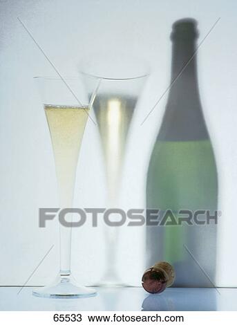 Stock Image - Close-up of bottle and Champagne flutes . Fotosearch