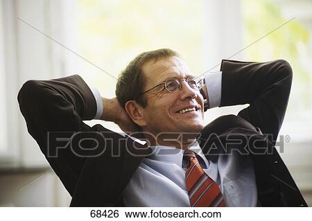 Stock Photograph - Close-up of businessman smiling in office . Fotosearch