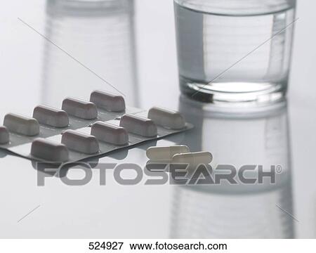 Close-up of capsules in blister pack and glass of water View Large Photo Image Stock Photo - Close-up of capsules in blister pack and glass of water . Fotosearch
