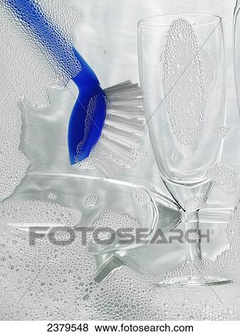 Stock Photo - Close-up of champagne flutes and brush with soap sud . Fotosearch