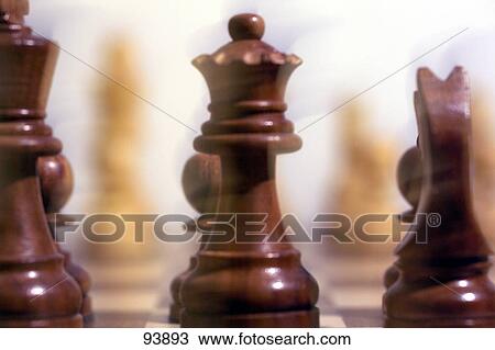 Stock Image - Close-up of chess pieces on chessboard . Fotosearch