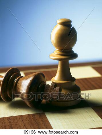 Close-up of chess pieces on chessboard View Large Photo Image Stock Photograph - Close-up of chess pieces on chessboard . Fotosearch