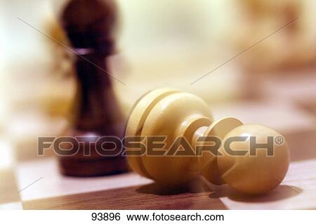 Close-up of chess pieces on chessboard View Large Photo Image Stock Photograph - Close-up of chess pieces on chessboard . Fotosearch