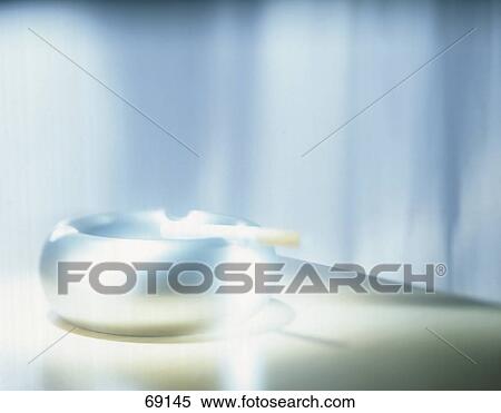 Stock Photography - Close-up of cigarette and ashtray . Fotosearch