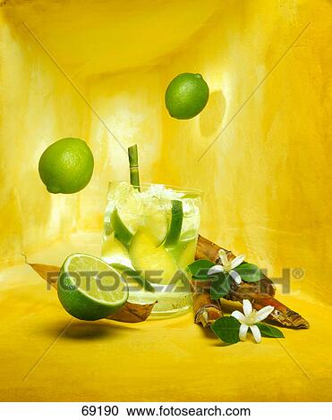 Stock Image - Close-up of cocktail rum with demerara sugar, lemon blossoms and lemons . Fotosearch