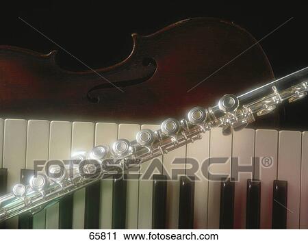 Close-up of flute and piano keys View Large Photo Image Stock Image - Close-up of flute and piano keys . Fotosearch
