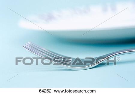 Stock Image - Close-up of fork and plate . Fotosearch