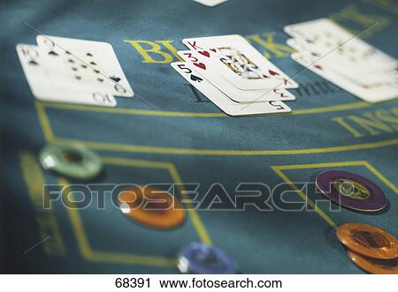 Stock Image - Close-up of gambling chips and playing cards . Fotosearch