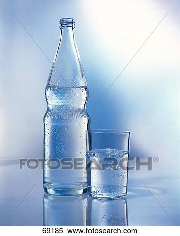 Close-up of glass and bottle of water View Large Photo Image Stock Photography - Close-up of glass and bottle of water . Fotosearch