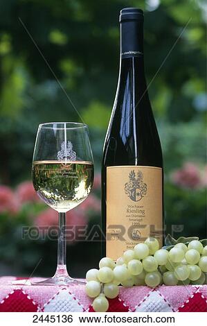 Close-up of glass and bottle of white wine with grapes View Large Photo Image Stock Photograph - Close-up of glass and bottle of white wine with grapes . Fotosearch