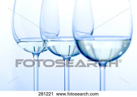 Stock Image - Close-up of glasses of white wine . Fotosearch