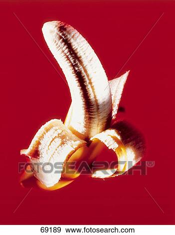Stock Photo - Close-up of half peeled banana . Fotosearch