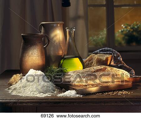Stock Photograph - Close-up of loaf of bread on cutting board . Fotosearch