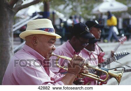 Stock Image - Close-up of man playing trumpet at roadside, Kapstadt, South Africa . Fotosearch
