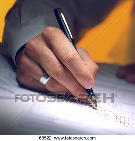 Stock Image - Close-up of man signing with fountain pen . Fotosearch
