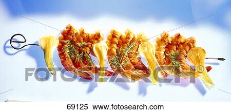 Stock Photography - Close-up of prawns and halves of onions in skewer . Fotosearch