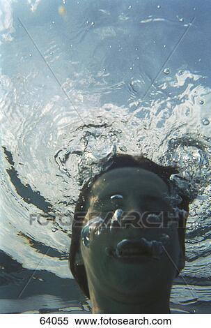 Close-up of teenage girl blowing water bubbles in swimming pool View Large Photo Image Stock Photography - Close-up of teenage girl blowing water bubbles in swimming pool . Fotosearch