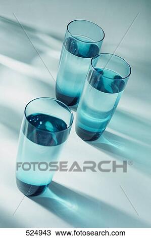 Stock Image - Close-up of three glasses full of water . Fotosearch