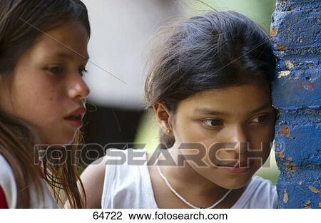 Close-up of two girls near brick wall View Large Photo Image Stock Image - Close-up of two girls near brick wall . Fotosearch