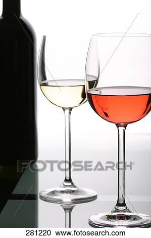 Stock Image - Close-up of two glasses of red and white wine . Fotosearch