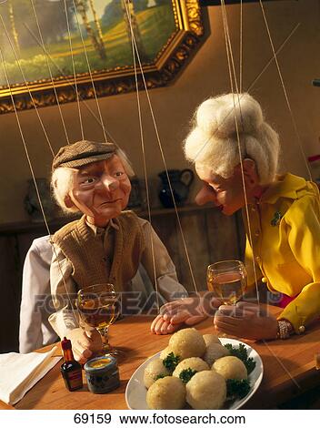 Close-up of two puppets at dinning table View Large Photo Image Stock Photo - Close-up of two puppets at dinning table . Fotosearch