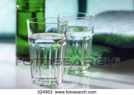 Close-up of two water glasses on table View Large Photo Image Stock Image - Close-up of two water glasses on table . Fotosearch