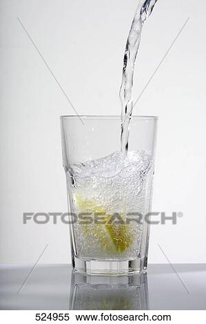 Stock Photography - Close-up of water being poured into glass . Fotosearch