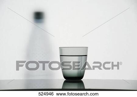 Close-up of water glass on table View Large Photo Image Stock Photograph - Close-up of water glass on table . Fotosearch