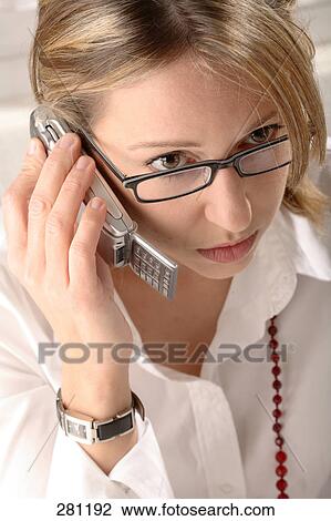 Stock Image - Close-up of young woman talking on mobile phone . Fotosearch