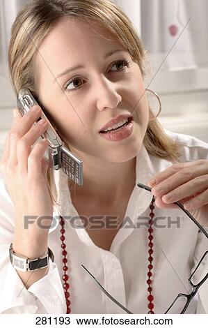 Close-up of young woman talking on mobile phone View Large Photo Image Stock Image - Close-up of young woman talking on mobile phone . Fotosearch