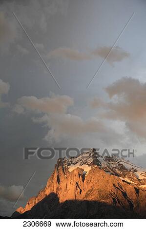Clouds over snowcapped mountain, Grindelwald, Bernese Oberland, Bern, Switzerland View Large Photo Image Stock Photo - Clouds over snowcapped mountain, Grindelwald, Bernese Oberland, Bern, Switzerland . Fotosearch