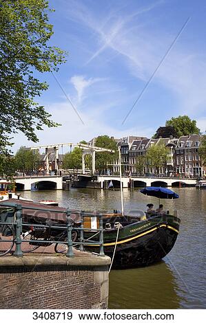 Couple on boat on the Amstel River, Amsterdam, Netherlands View Large Photo Image Stock Photo - Couple on boat on the Amstel River, Amsterdam, Netherlands . Fotosearch