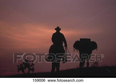 Cowboy horseback riding View Large Photo Image Stock Photograph - Cowboy horseback riding . Fotosearch