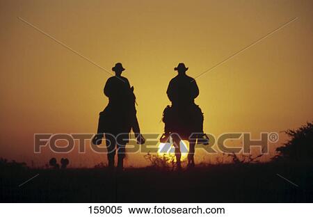 Cowboys horseback riding View Large Photo Image Stock Photography - Cowboys horseback riding . Fotosearch