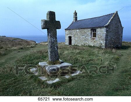 Stock Image - Cross in front of chapel, St. Samson Chapel, Finistere, Brittany, France . Fotosearch