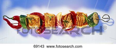 Cubes of meat and red chilli peppers with slices of cucumbers on skewer View Large Photo Image Stock Image - Cubes of meat and red chilli peppers with slices of cucumbers on skewer . Fotosearch