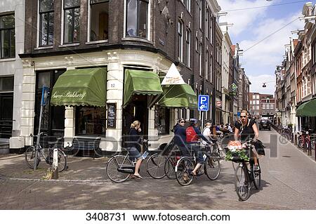 Stock Image - Cyclists at a street corner, Amsterdam, Netherlands . Fotosearch