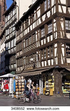 Stock Image - Cyclists in front of a gift shop, Strasbourg, France . Fotosearch