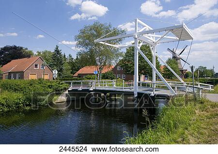 Picture - Drawbridge across canal, Grossefehnkanal, Ostgrossefehn, Lower Saxony, Germany . Fotosearch